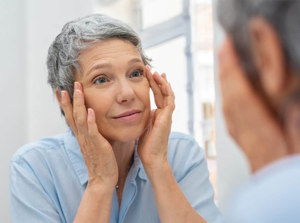 Mature woman looking in the mirror