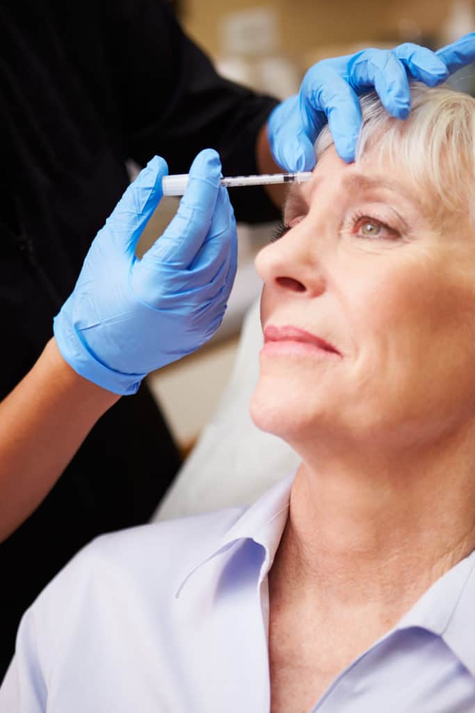 Woman Having Botox Treatment At Beauty Clinic