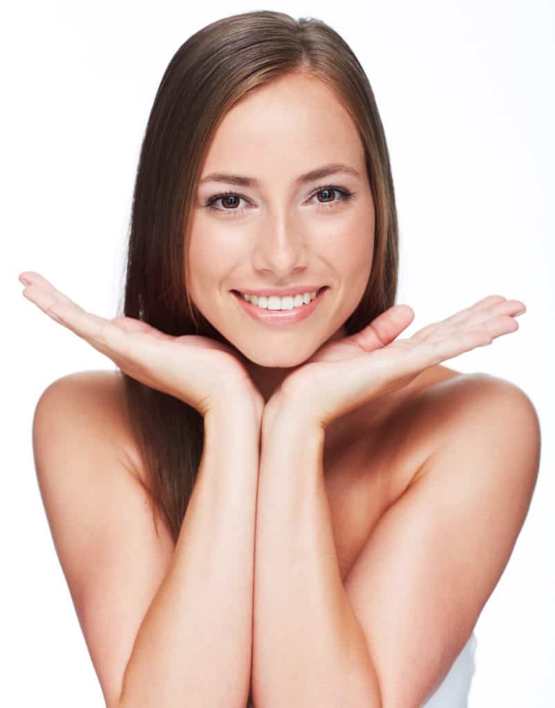 Portrait of young woman against white background